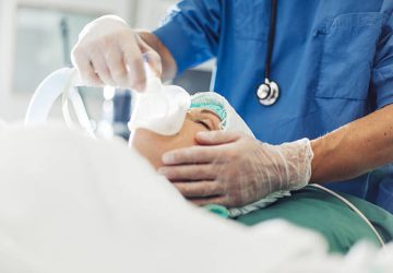 Anesthetic nurses in operation room at hospital with patient